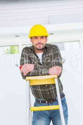 Repairman with pliers on ladder