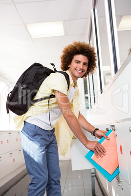 Casual young man with folders in office