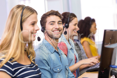 Students using headsets in computer class