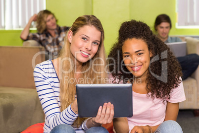 Young women using digital tablet in office