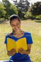 Woman reading book in park