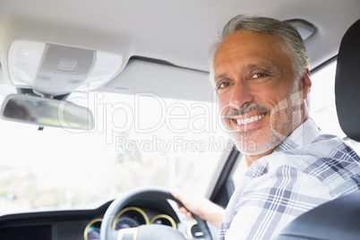 Man smiling while driving