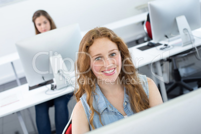 Smiling female student in computer class