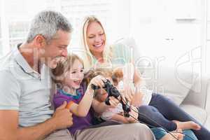 Parents looking at children playing video game