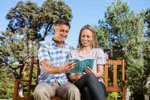 Couple relaxing in the park on bench