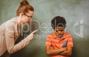 Teacher shouting at boy in classroom