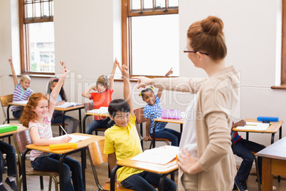 Pupils raising their hands during class