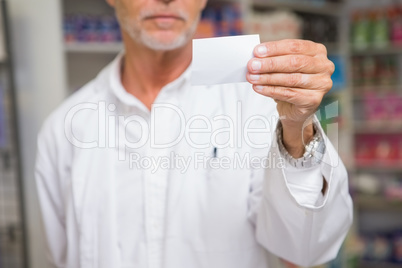 Senior pharmacist holding calling card