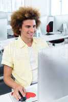 Smiling male student in computer class