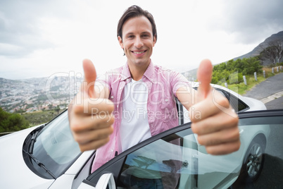 Man smiling at camera with thumbs up