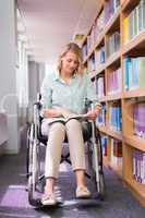 Smiling disabled student in library picking book