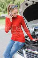 Young woman looking at engine