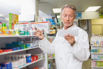 Concentrated pharmacist reading prescription