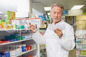 Concentrated pharmacist reading prescription