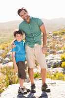 Father and son hiking through mountains