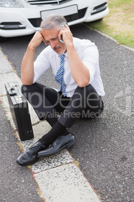 Sad man calling for assistance after breaking down