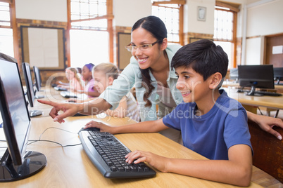 Cute pupils in computer class with teacher