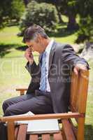 Businessman thinking in the park
