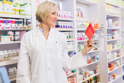 Smiling pharmacist holding envelope