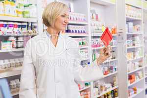 Smiling pharmacist holding envelope