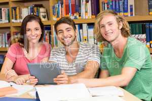 College students using digital tablet in library