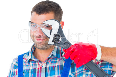 Repairman looking through adjustable wrench