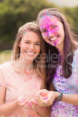 Happy friends covered in powder paint