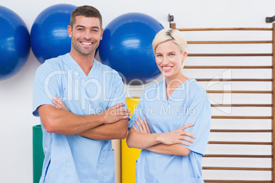 Team of therapists with arms crossed smiling at camera