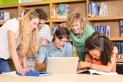 College students using laptop in library