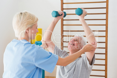 Senior man working out with his therapist