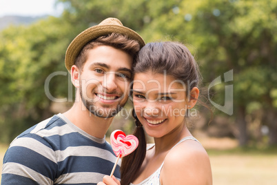 Cute couple sharing a lollipop