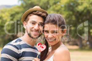 Cute couple sharing a lollipop