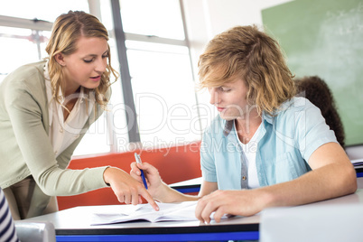 Teacher helping student in class Teacher helping student in class