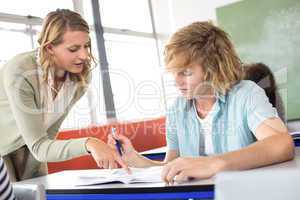 Teacher helping student in class