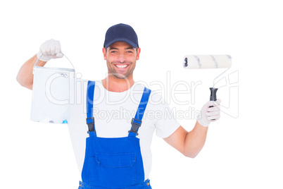 Smiling handyman with paint can and roller