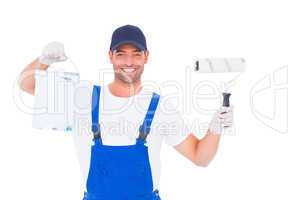 Smiling handyman with paint can and roller