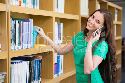 Student using her phone in library