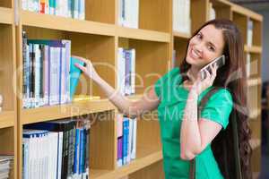 Student using her phone in library