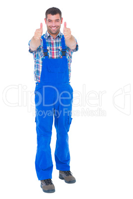 Happy handyman in coveralls gesturing thumbs up