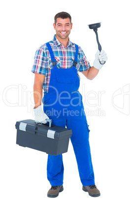 Portrait of happy plumber with plunger and toolbox