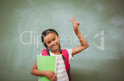 Portrait of cute little girl holding book