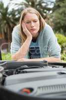 Thoughtful woman looking at engine