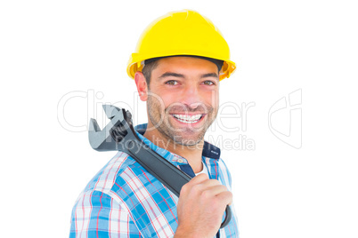 Smiling manual worker holding adjustable spanner
