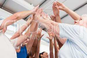 Cheerful friends with hands raised