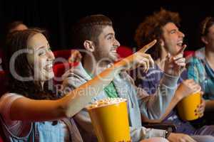 Young friends watching a film