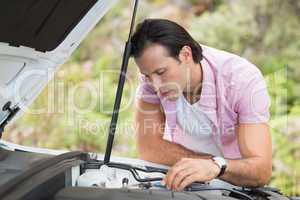 Stressed man looking at engine