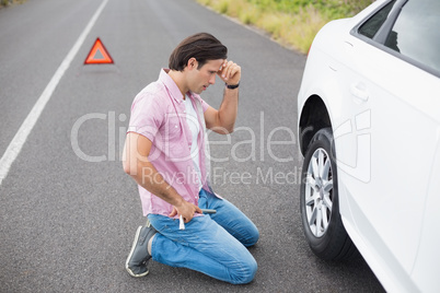 Man changing wheel after a car breakdown