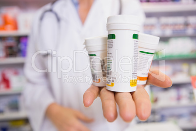 Pharmacist presenting medications on her hand