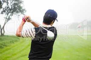 Golfer teeing off