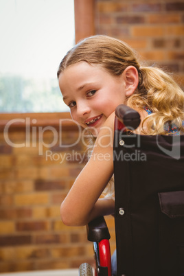 Portrait of cute girl sitting in wheelchair